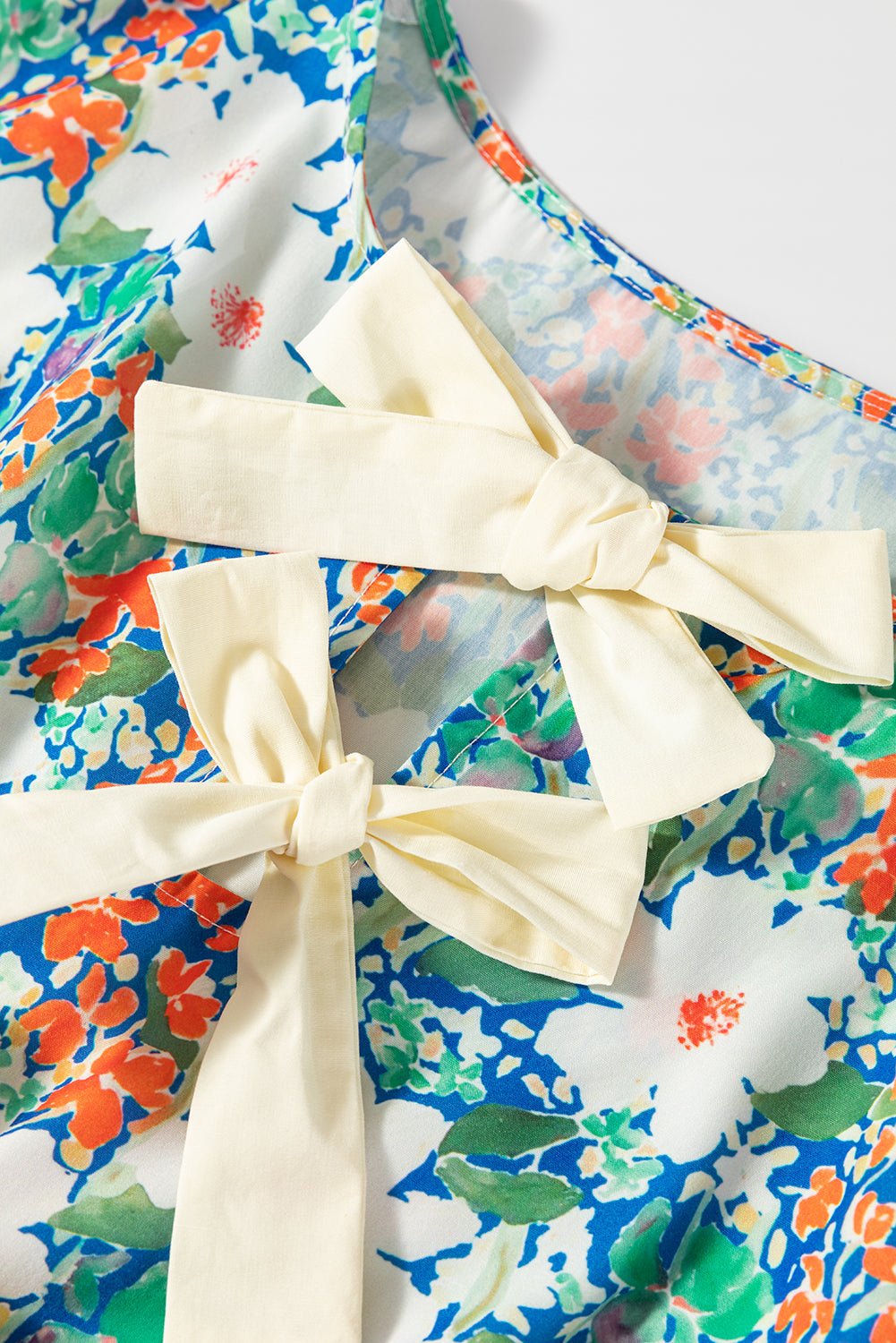 Floral Bow Tie Sleeveless Peplum Blouse - Rooted & Reckless Co.
