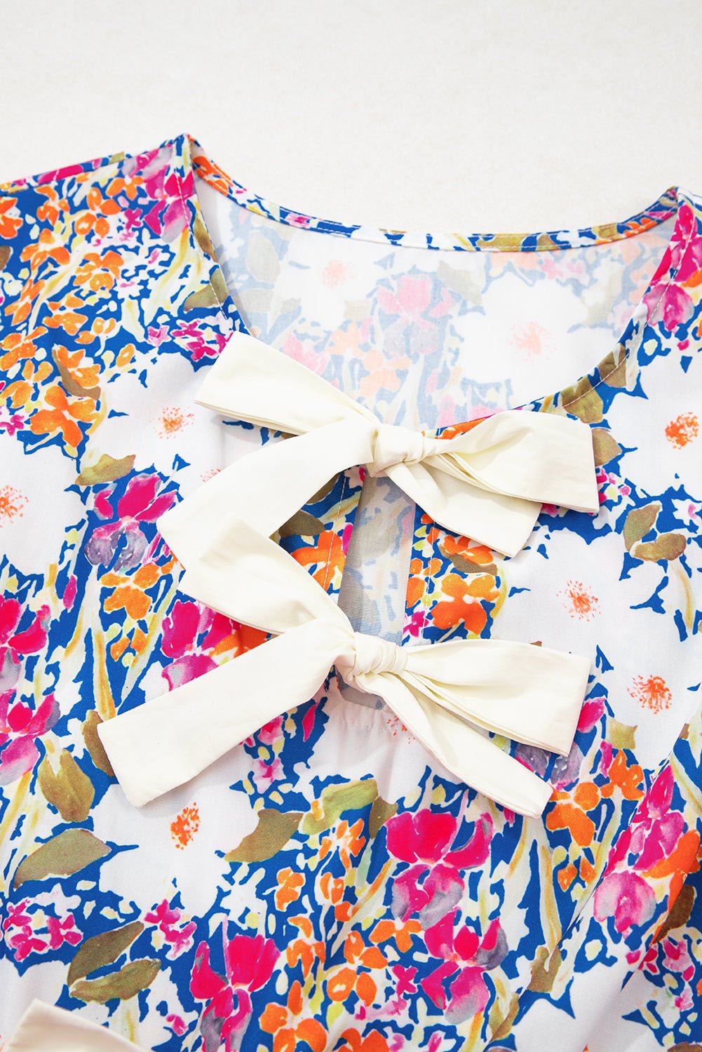Floral Bow Tie Sleeveless Peplum Blouse - Rooted & Reckless Co.