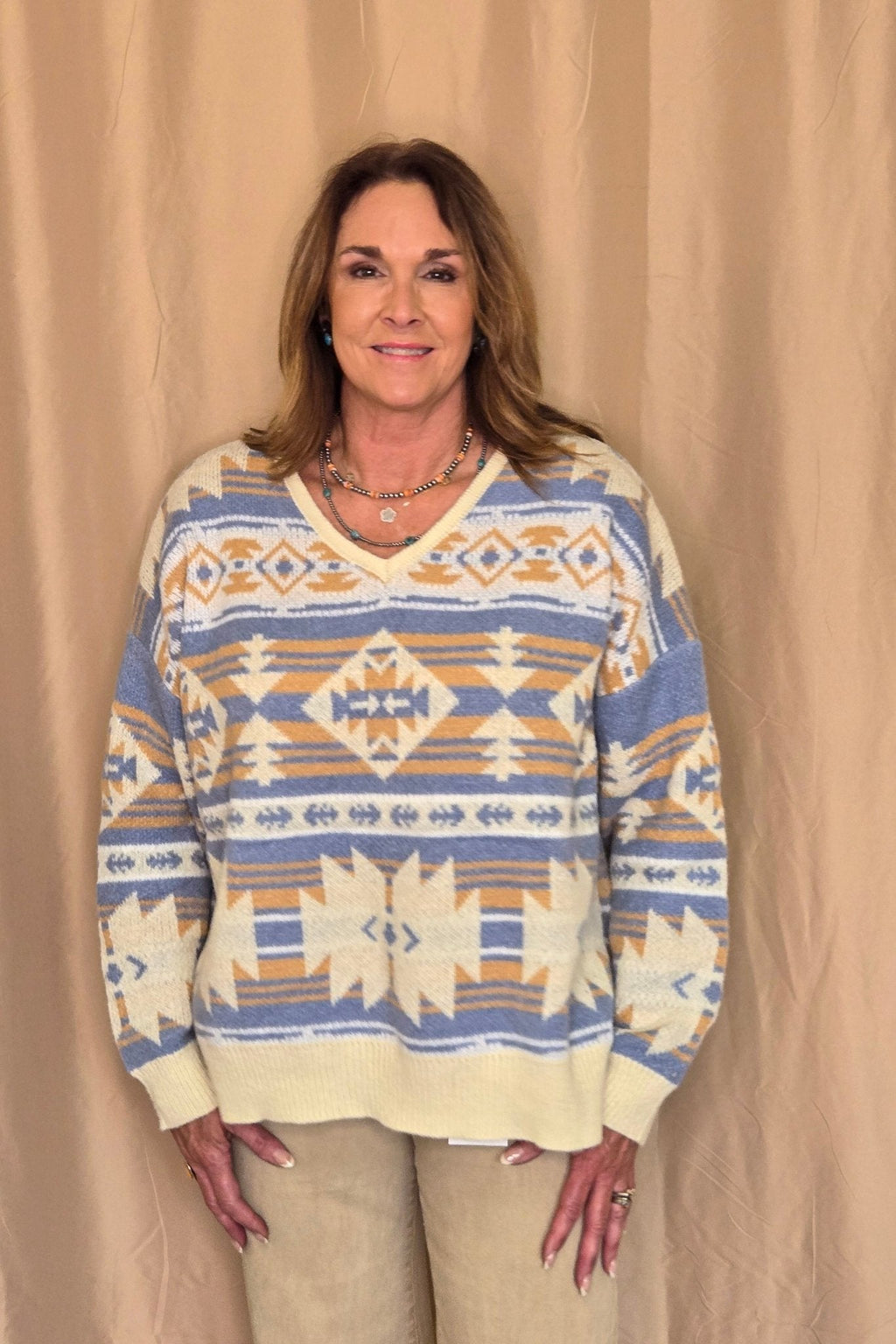 Main Strip Southwestern Knit Sweater — Oversized V-Neck with Bold Blue, Tan & Cream Print - Rooted & Reckless Co.