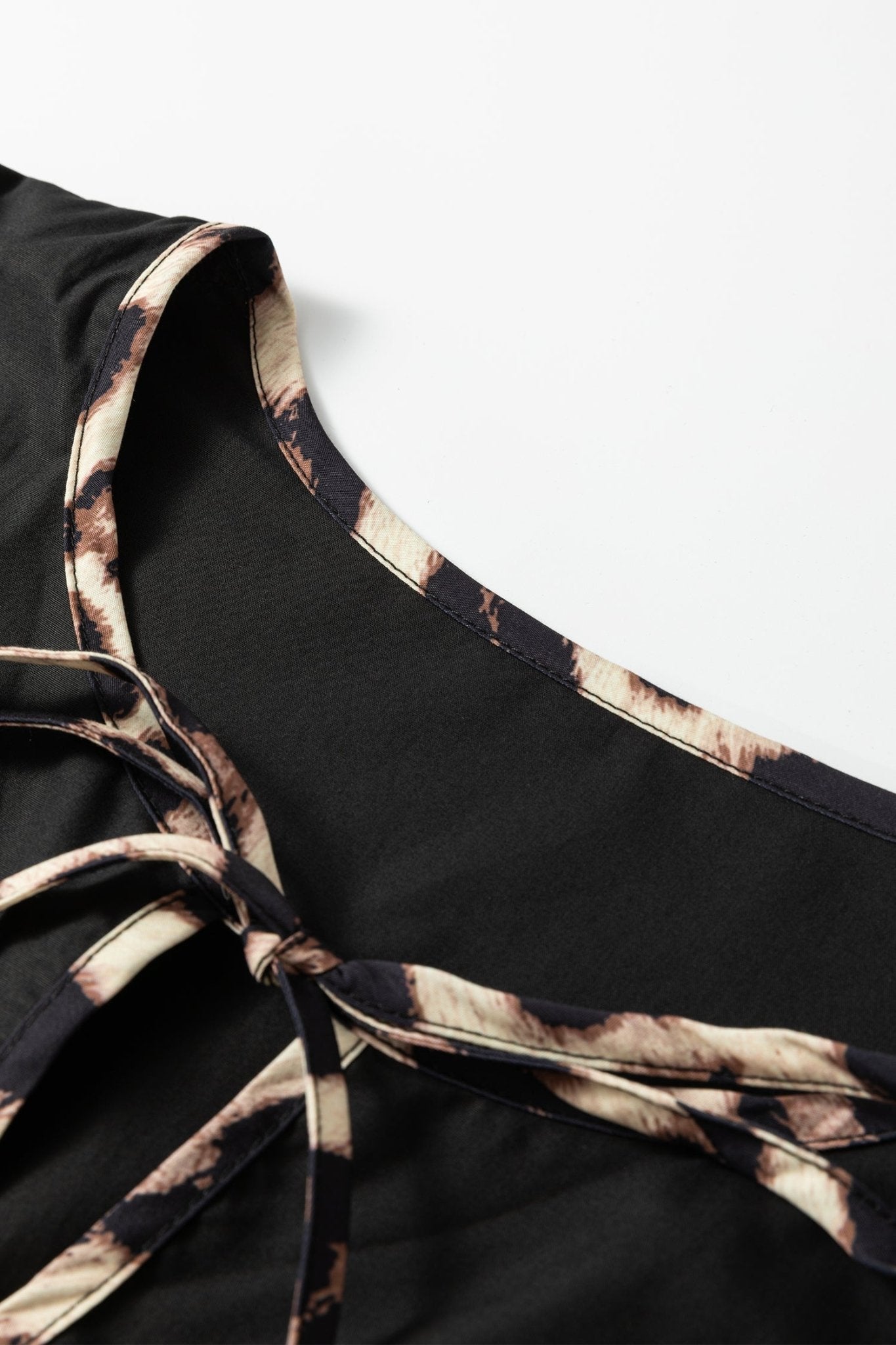 Plus Size Leopard Contrast Trim Tie-Neck Mini Dress - Rooted & Reckless Co.